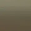 A blurry photo of a bird flying in the sky.